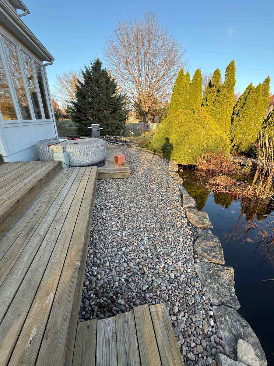 Clean landscaping with river rock pathway